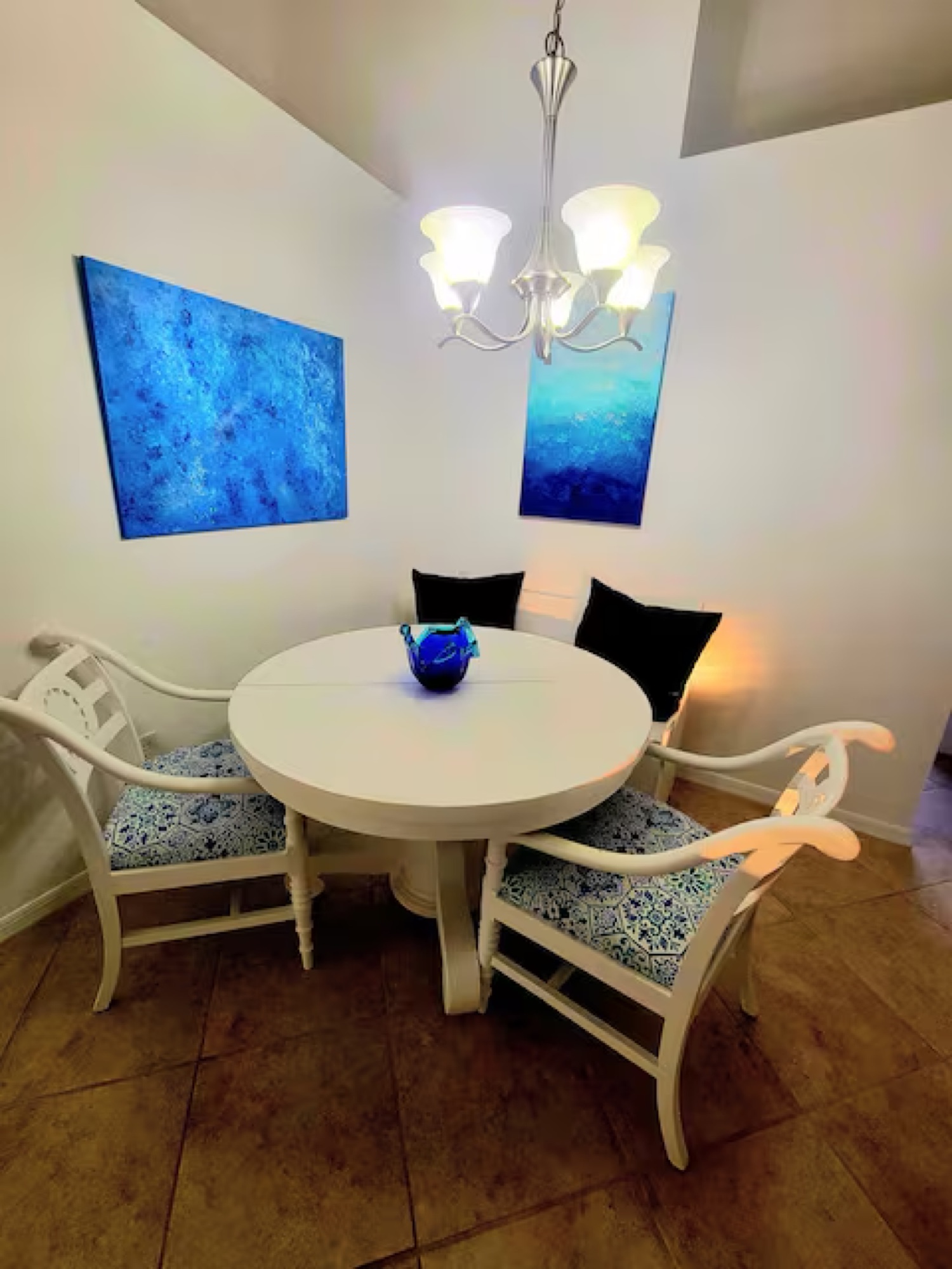 Dining room with chandelier and slipcovered chairs