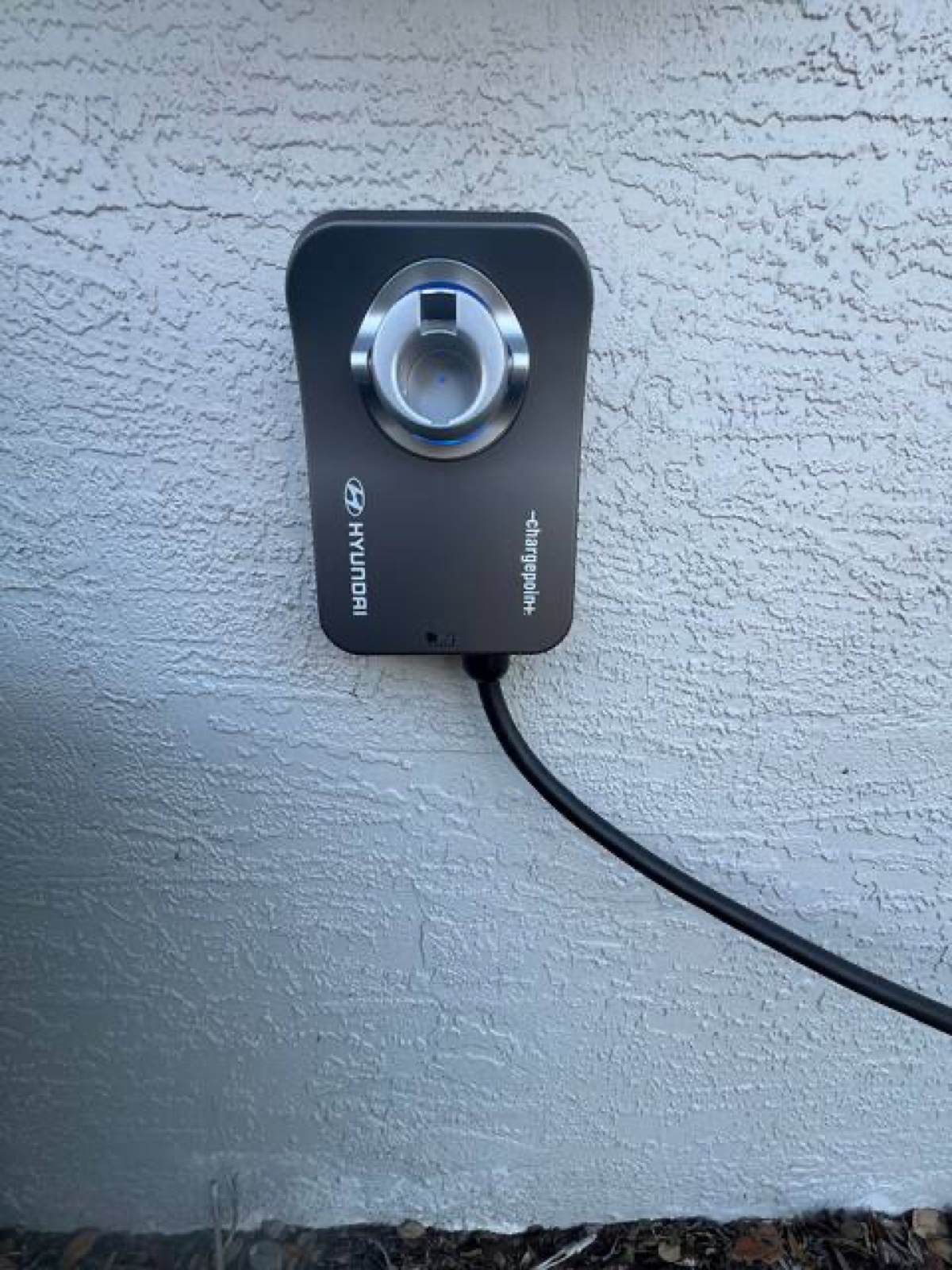 ChargePoint Level 2 EV charger mounted on the side of the home, remotely locked until activated by the owner
