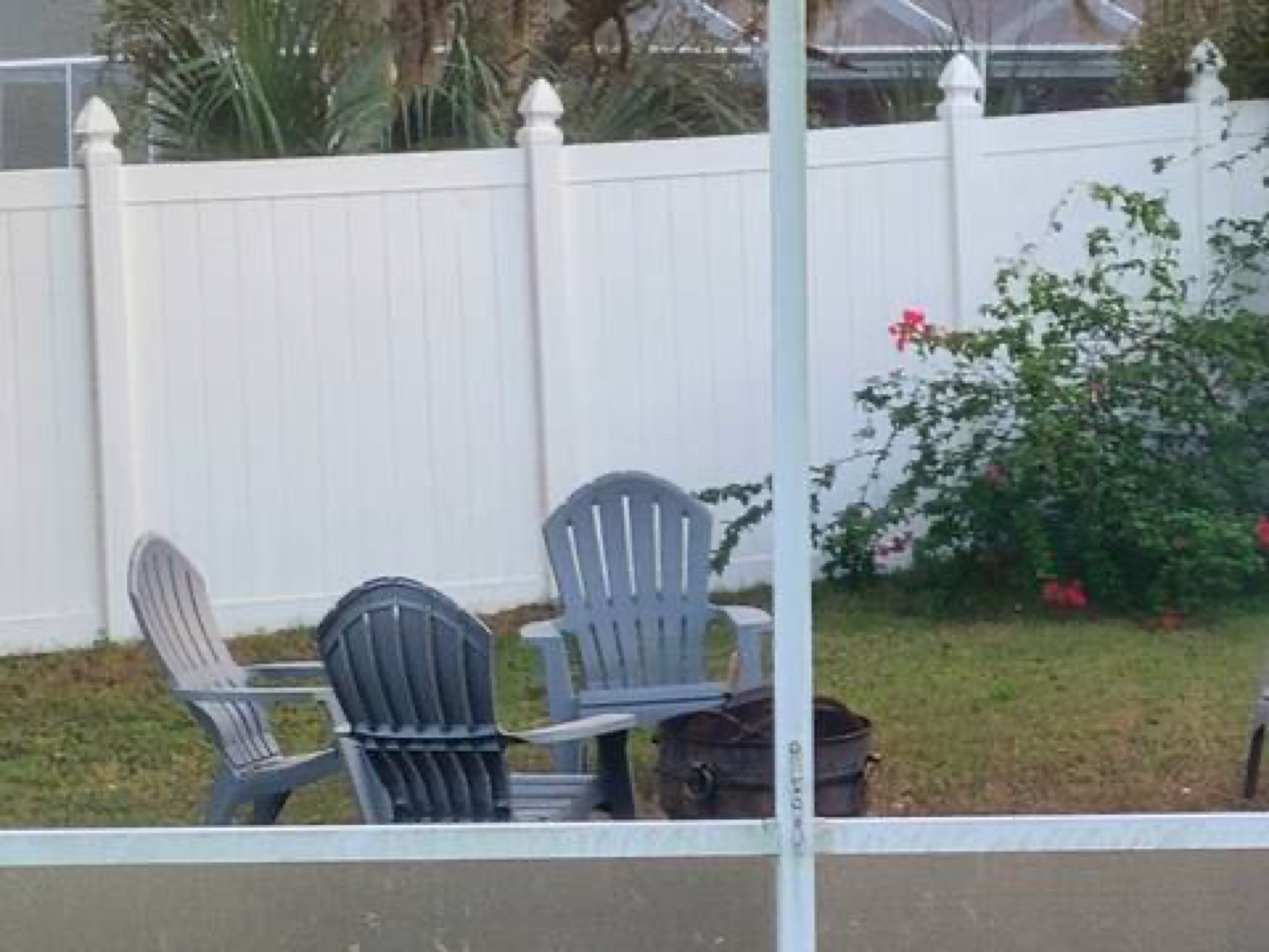 Fire pit and Adirondack chairs in the backyard