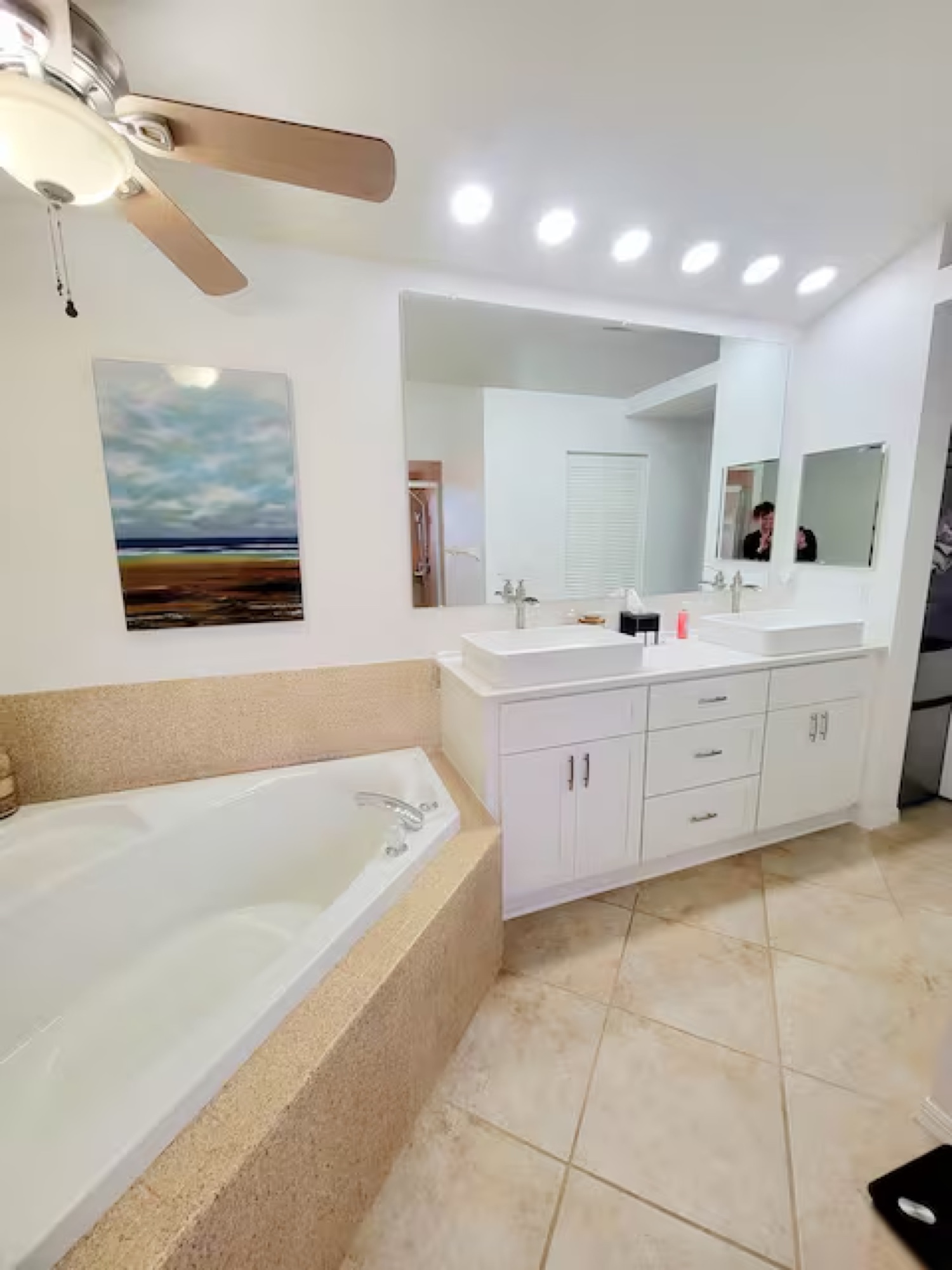 Primary bathroom with double vanity and soaking tub