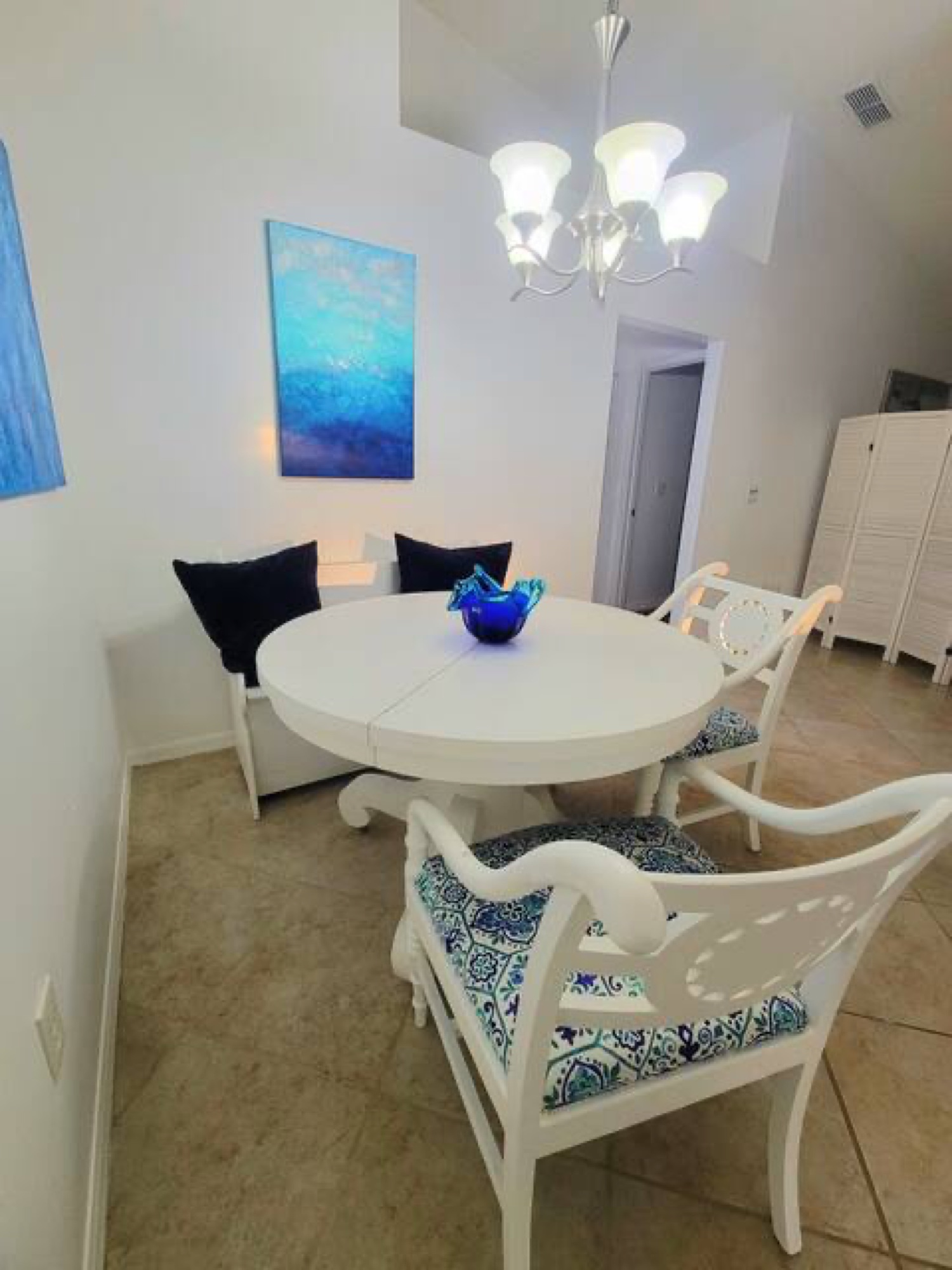 Breakfast nook off the kitchen with cushioned bench and coastal accents